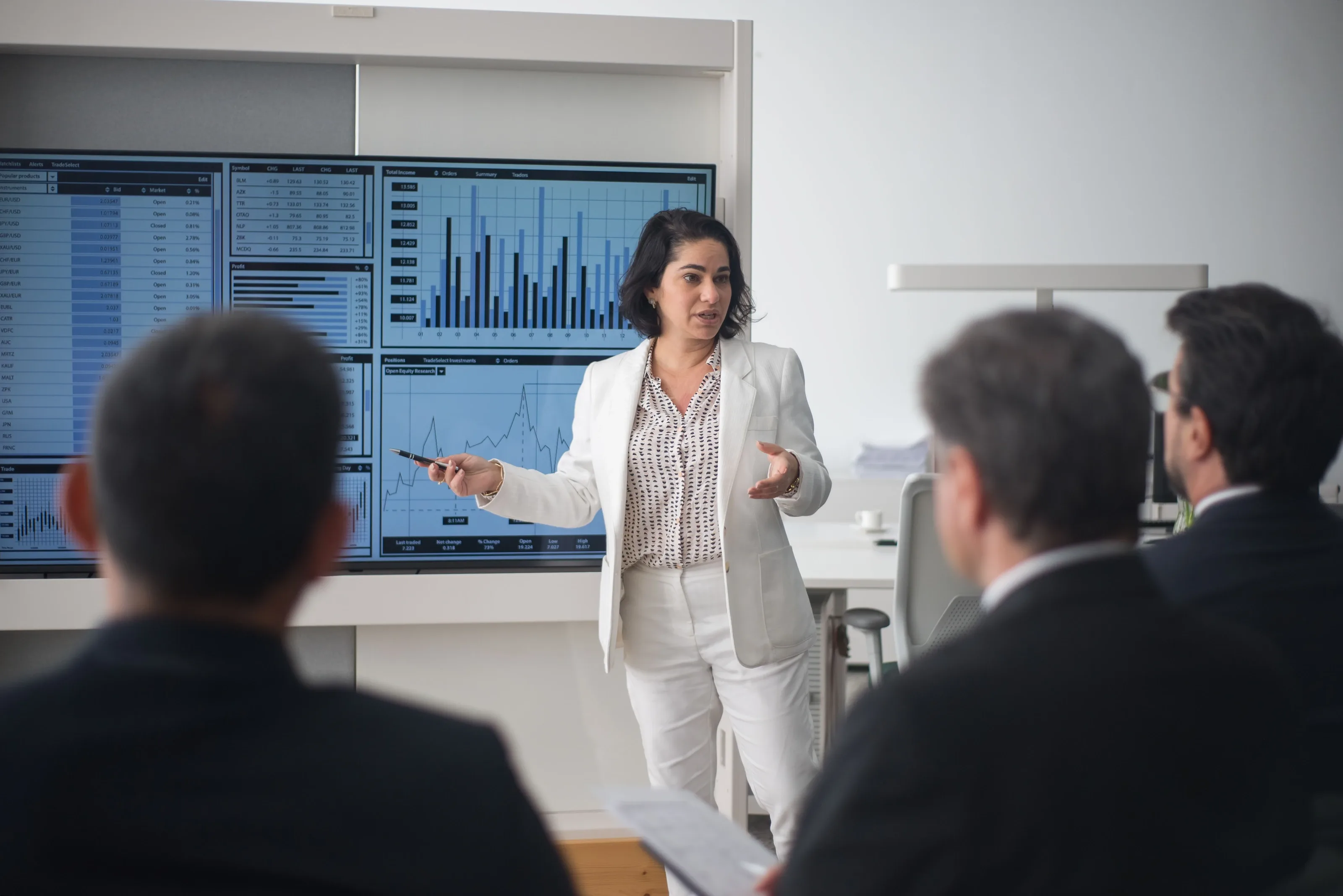 Tutor answering questions from delegates in a bright training room